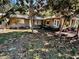Ranch-style home with brown exterior and landscaping at 12151 Se 86Th Ave, Belleview, FL 34420