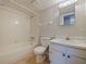 Clean bathroom with white vanity, tiled tub/shower, and wood-look walls at 127 Springwood Cir # A, Longwood, FL 32750