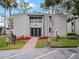 Building exterior with landscaped entryway and parking area at 127 Springwood Cir # A, Longwood, FL 32750