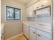 White kitchen with ample cabinetry, dishwasher, and a double sink at 127 Springwood Cir # A, Longwood, FL 32750