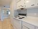 White kitchen with stove, cabinets, and view of dining area at 127 Springwood Cir # A, Longwood, FL 32750