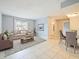 Bright living room with dining area, featuring tiled floors and neutral colors at 127 Springwood Cir # A, Longwood, FL 32750