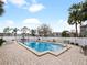 Community pool with brick patio, lounge chairs, and palm trees at 127 Springwood Cir # A, Longwood, FL 32750