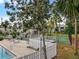 Community pool and tennis courts with lounge chairs and surrounding landscape at 127 Springwood Cir # A, Longwood, FL 32750