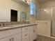 Main bathroom boasts double vanity, granite countertop, and a walk-in shower at 16704 Point Rock Dr, Winter Garden, FL 34787