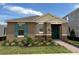One-story home with teal shutters, landscaping, and a brick walkway at 16704 Point Rock Dr, Winter Garden, FL 34787