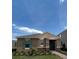 Front view of a one-story house with a teal door and landscaping at 16704 Point Rock Dr, Winter Garden, FL 34787