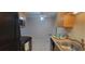 Eat-in kitchen with wood cabinets, black appliances, and tile floor at 1695 Lee Rd # A209, Winter Park, FL 32789