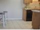 Kitchen with wood cabinets, black appliances, and tile floor at 1695 Lee Rd # A209, Winter Park, FL 32789