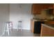 Kitchen area with wood cabinets and tile floors at 1695 Lee Rd # A209, Winter Park, FL 32789