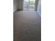 Living room with access to a balcony and carpeted floors at 1695 Lee Rd # A209, Winter Park, FL 32789