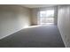 Living room with grey carpet and sliding glass doors to balcony at 1695 Lee Rd # A209, Winter Park, FL 32789