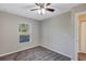 Spacious bedroom with ceiling fan and access to bathroom at 17 Walnut Crse, Ocala, FL 34480