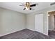 Comfortable bedroom with ceiling fan, double door closet and carpet flooring at 17 Walnut Crse, Ocala, FL 34480
