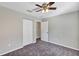 Well-lit bedroom with ceiling fan and carpet flooring at 17 Walnut Crse, Ocala, FL 34480