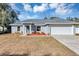 Gray house with a two-car garage and landscaping at 17 Walnut Crse, Ocala, FL 34480