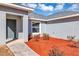 Gray front door with red mulch landscaping at 17 Walnut Crse, Ocala, FL 34480