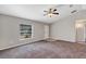 Open living room featuring grey carpet, neutral walls and ceiling fan at 17 Walnut Crse, Ocala, FL 34480