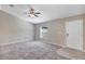 Spacious living room with grey carpeting and a ceiling fan at 17 Walnut Crse, Ocala, FL 34480