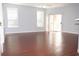 Living room with hardwood floors and sliding door to balcony at 2025 Erving Cir # 207, Ocoee, FL 34761