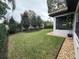 Landscaped backyard with a large grassy area and gravel border at 205 Hazard St, Orlando, FL 32804