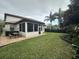 Large backyard featuring a screened porch and patio furniture at 205 Hazard St, Orlando, FL 32804
