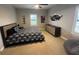 Bedroom features a black and white patterned bedspread, light-filled windows, and neutral carpeting at 205 Hazard St, Orlando, FL 32804