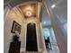 Grand entryway featuring an arched doorway, a decorative chandelier, and elegant architectural details at 205 Hazard St, Orlando, FL 32804