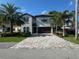 Charming two-story home with a paver driveway, and well-maintained landscaping and lush trees at 205 Hazard St, Orlando, FL 32804