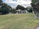 Large green area with mature trees and distant homes at 205 Hazard St, Orlando, FL 32804