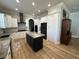 Kitchen featuring black kitchen island, stainless steel appliances, and white cabinets at 205 Hazard St, Orlando, FL 32804