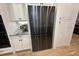 Stainless steel fridge is surrounded by white cabinets and granite counters at 205 Hazard St, Orlando, FL 32804