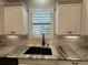 Kitchen featuring windowed cabinets, granite counter tops and a sink at 205 Hazard St, Orlando, FL 32804