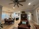 Open-concept living room with leather furniture, fireplace, ceiling fan and light hardwood floors at 205 Hazard St, Orlando, FL 32804