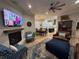Cozy living room with a fireplace, large TV, comfortable seating, and stylish decor at 205 Hazard St, Orlando, FL 32804