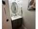 Elegant powder room with a gray vanity and decorative mirror at 205 Hazard St, Orlando, FL 32804