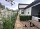 Side yard with a stone path, hedges, and a picnic table at 205 Hazard St, Orlando, FL 32804