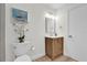 Bathroom with a single sink vanity and wood cabinet at 211 Lynn St, Oviedo, FL 32765