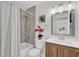 Clean bathroom with a tub, shower, and wood vanity at 211 Lynn St, Oviedo, FL 32765
