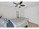Second bedroom with metal bed frame and blue and white bedding at 211 Lynn St, Oviedo, FL 32765