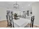 Elegant dining room with a modern chandelier and seating for six at 211 Lynn St, Oviedo, FL 32765