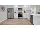 Modern kitchen featuring stainless steel appliances and white shaker cabinets at 211 Lynn St, Oviedo, FL 32765