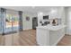 Open kitchen with island, stainless steel appliances, and access to the pool at 211 Lynn St, Oviedo, FL 32765