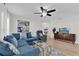 Cozy living room featuring a blue sectional sofa and wood flooring at 211 Lynn St, Oviedo, FL 32765
