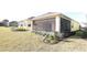 Home features a screened lanai and a nicely landscaped backyard at 240 Blue Starfish Pl, Daytona Beach, FL 32124