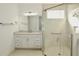 Bright bathroom featuring granite countertop vanity and frameless glass shower stall with tile surround at 240 Blue Starfish Pl, Daytona Beach, FL 32124