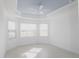 Spacious bedroom with light-colored walls, tile flooring, and a tray ceiling at 240 Blue Starfish Pl, Daytona Beach, FL 32124