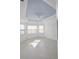 Spacious bedroom with light-colored walls, tile flooring, and a tray ceiling at 240 Blue Starfish Pl, Daytona Beach, FL 32124