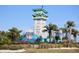 Attractive community entrance with tropical landscaping at 240 Blue Starfish Pl, Daytona Beach, FL 32124
