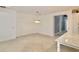 Open dining area with large chandelier and view to kitchen at 240 Blue Starfish Pl, Daytona Beach, FL 32124